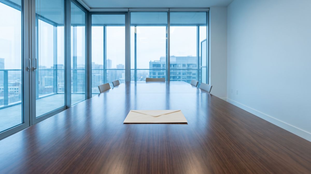 A single sealed envelope on an empty conference table, illustrating that a Context quote only exists after a procurement conversation